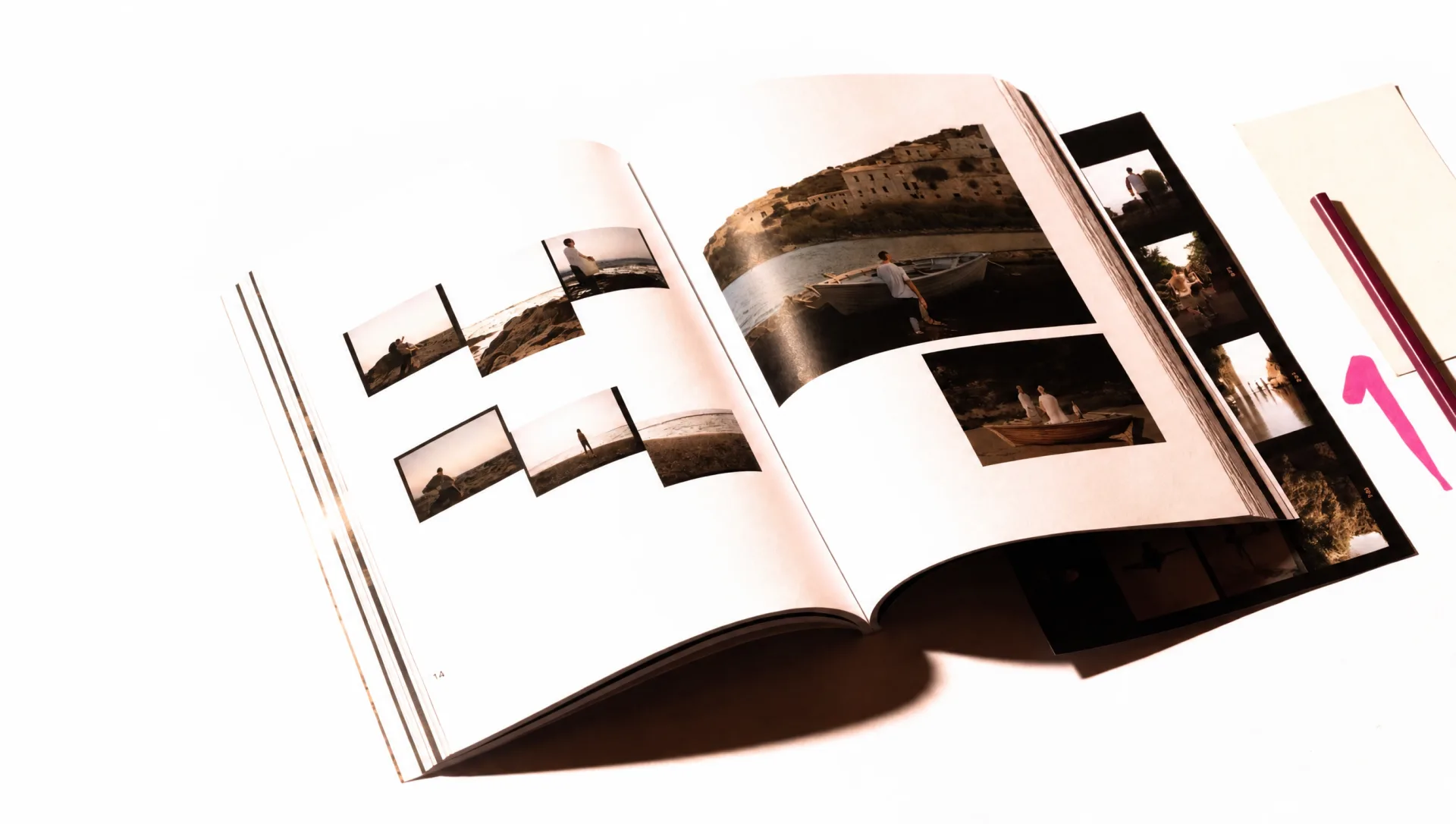Open magazine spread with European waterfront photographs and a contact sheet